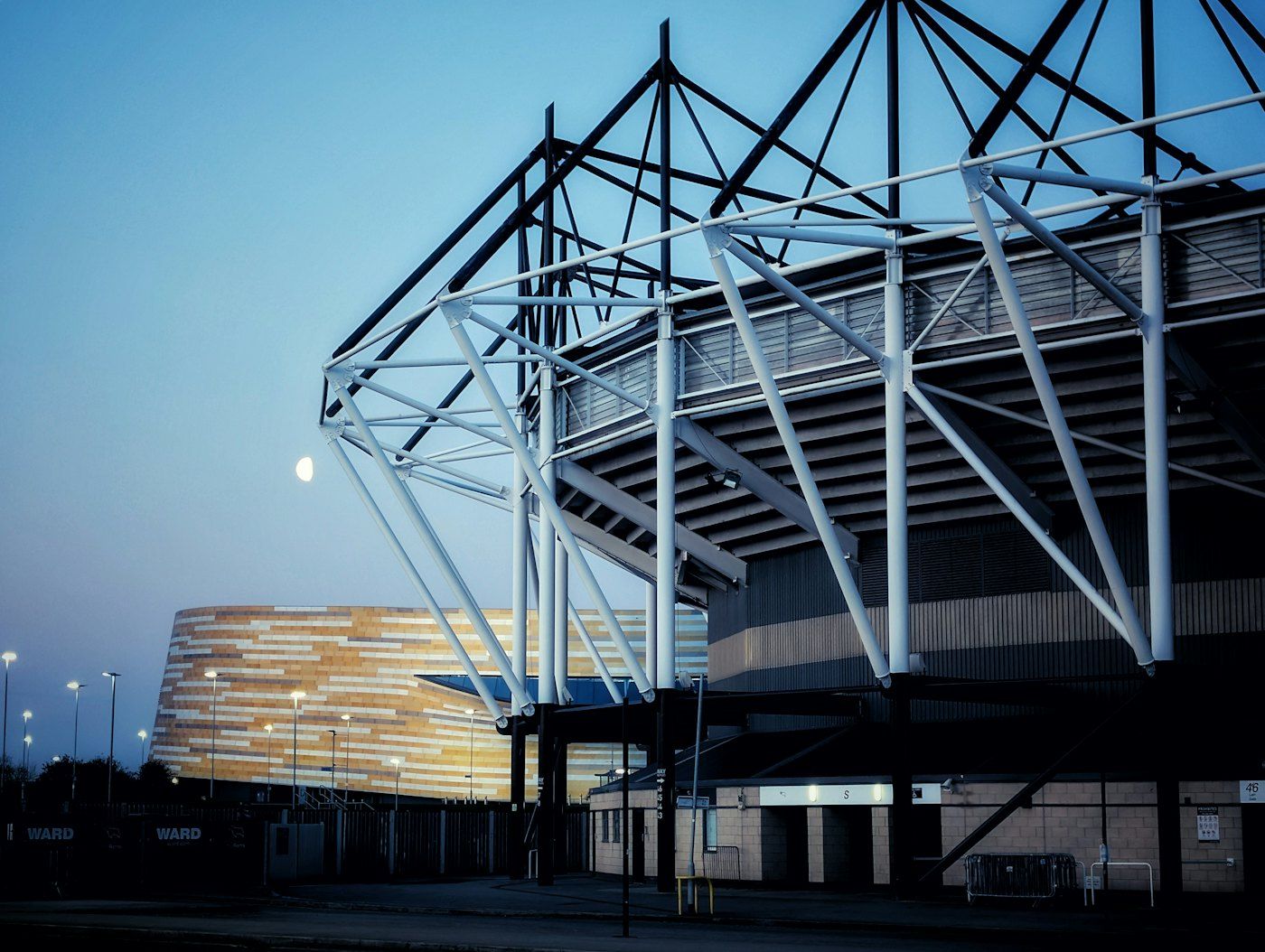 Modern stadium steel facade at twilight